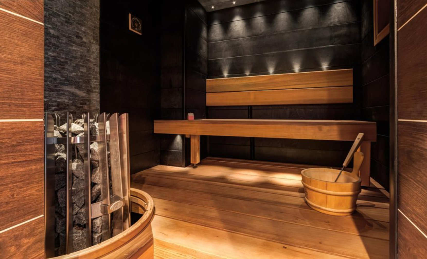 Cedar sauna with heater and bucket, serviced by Aquaman Pool & Spa Repair